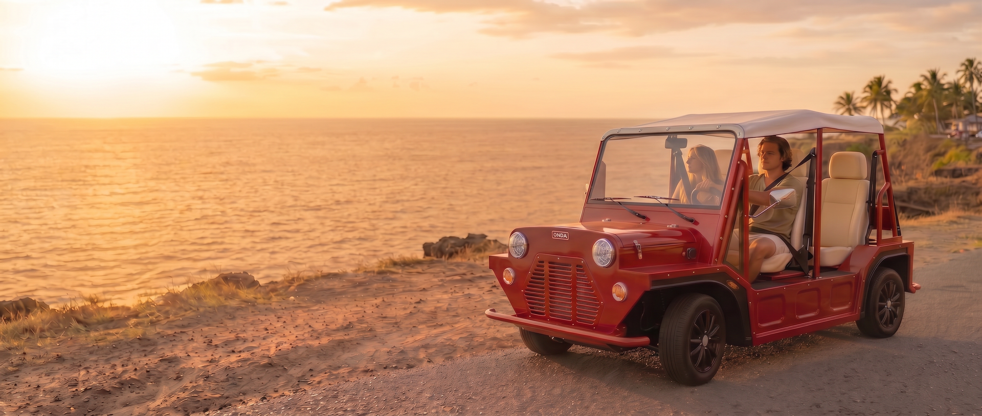 Red Onda EV on a scenic coastal road at sunset